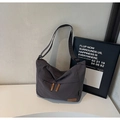 Detail of waterproof grey canvas tote showing leather brand tag and textured fabric - Dark Gray