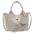 Chic beige lychee textured leather tote bag with gold hardware and puppy charm - Off White