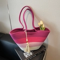 Handmade woven tote bag with pink gradient colors and tassel detail in a lifestyle setting - Rose Red