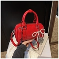 Glossy red Boston bag featuring pearl bow charm and detachable leather strap - With Charm / Red