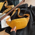 Bright yellow nylon waist bag with jacquard strap shown on black fabric background - Yellow