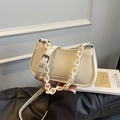 Creamy white dumpling bag with chunky plastic chain strap and fine leather cross-body strap - White