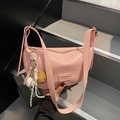 Pink lychee grain crescent shoulder bag with baseball charms and metal zipper - Pink with Pendant