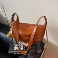 Brown semi-circle PU leather shoulder bag with decorative baseball glove charm and strap - Brown with Pendant