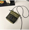 Olive green nylon crossbody bag with black mesh pocket and rope strap in utility style - Army Green