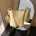 Fashionable light yellow bucket bag with cartoon pearl pendant and adjustable strap - With Charm / Yellow