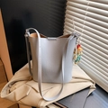 Minimalist light blue-grey bucket bag with a cute cartoon doll pendant and slim strap - With Charm / Blue