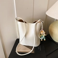 White bucket shoulder bag in pebble grain faux leather with a pearl doll charm - With Charm / White