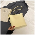 Pale yellow leather bucket bag with brand logo embossing and minimalist shoulder strap - No Pendant / Yellow