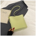 Minimalist avocado green leather bucket bag with shoulder strap on a white sheet - No Pendant / Green