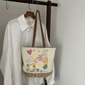 Borsa tote in tela crema con base intrecciata, manici in pelle e stampe colorate - Stile Fiore