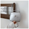 Detail of silver metallic square bag featuring circular logo and adjustable crossbody strap - Silver