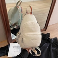 Mini-Rucksack in Creme mit buntem Ethno-Webgurt und modernem geprägtem Textdetail - Gebrochenes Weiß