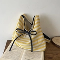 Chic yellow and white striped canvas tote bag with a decorative black bow detail - Yellow