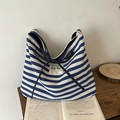 Blue and white striped canvas tote bag with black bow and 'SEE YOU' woven label detail - Blue