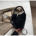 Detail view of black lychee grain bucket bag with silk scarf on handle and fashion stamp - Black