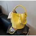 Detail of yellow lychee pattern bucket bag with decorative scarf and fashion stamp - Yellow