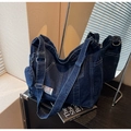 Detail of blue denim tote bag with contrast stitching and mini round coin purse - Dark Blue