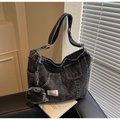 Detail of black washed denim tote bag featuring utility pockets and mini coin purse charm - Black