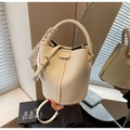 Detail of off-white lychee leather bucket bag with silk scarf handle and embossed logo - Off-white