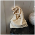 Detailed close-up of cream textured puff fabric tote bag with soft 3D pleated surface - Off White