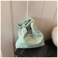 Detail of light green bubble textured tote bag with unique pleated fabric and soft shadow - Green