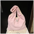 Macro shot of light pink popcorn texture fabric and minimalist Korean style label - Pink