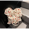 Chic cream tote bag featuring red cherry prints and stylish scrunchie handles - Off White