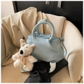 Detail of light blue lychee pattern leather bucket bag with a cute plush puppy charm - With Charm / Blue