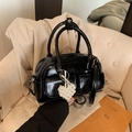 Glossy black Boston bag with twin handles, front pockets and pearl heart charm decor - Black (with Pendant)