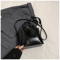 Sleek black glossy bucket bag with spherical metallic hardware and crossbody strap - Black (Without Charm)
