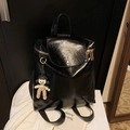 Glossy black faux leather backpack for women featuring gold hardware and a cute charm - Black with Pendant