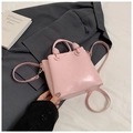 Pink minimalist bucket bag with woven knot handle and detachable crossbody shoulder strap - Pink (No Charm)