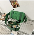 Detailed macro view of grass green nylon sports waist bag with black buckle on metal rack - Turquoise Green