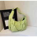 Detail of light green nylon hobo bag showing drawstring pockets and wide shoulder strap - Apple Green