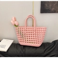 Detailed view of pink woven hollow silicone beach tote bag with round handles and flowers - Pink