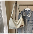 Detail of cream large tote bag with adjustable strap and brand logo on hanger - Light Green