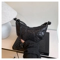 Detailed shot of black sequined crescent bag with leather strap and knot details - Black