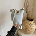 Light blue pebbled leather bucket bag with gold hardware and top handle strap - Blue