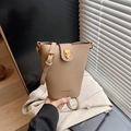 Minimalist khaki bucket bag in litchi grain leather with HOCOMU brand logo and gold hardware - Khaki