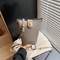 Minimalist grey bucket bag with lychee leather texture and gold hardware detailing - Elephant Gray