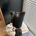 Minimalist black lychee texture bucket bag with gold hardware and adjustable strap - Black