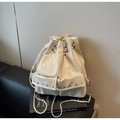Detail showing cream leather bucket bag with drawstring closure and metal chain strap - Off-white