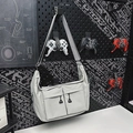 Light gray multi-pocket nylon crossbody bag with wide strap on industrial metal background - Gray