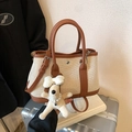 Brown leather and beige canvas bucket bag with cute plush puppy charm accessory - Brown with Pendant