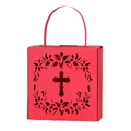 Macro shot of red hollow-out paper candy box featuring cross and floral wreath pattern - Pearlescent Red
