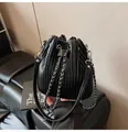 Black pleated bucket bag featuring a drawstring closure and silver chain strap - Black