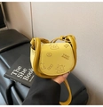 Detail of yellow mini saddle bag with embossed cartoon bear and textured leather finish - Yellow