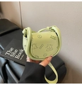 Detail of pistachio green saddle bag featuring embossed cartoon patterns and logo - Green