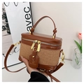 Detail of a brown leather and woven straw box bag featuring gold hardware and logo tag - Brown